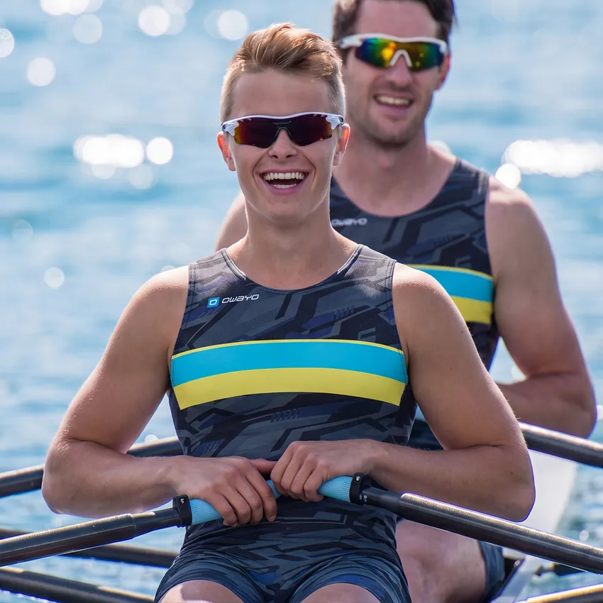 Two rowers in a boat wear stylish, customized sportswear featuring a modern pattern and vibrant colors.